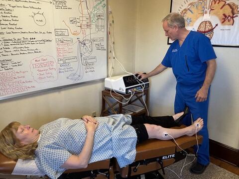 Dr. Schaffer at a nerve therapy unit with a patient