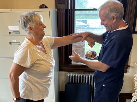 Dr. Schaffer working on a patient's shoulder mobility