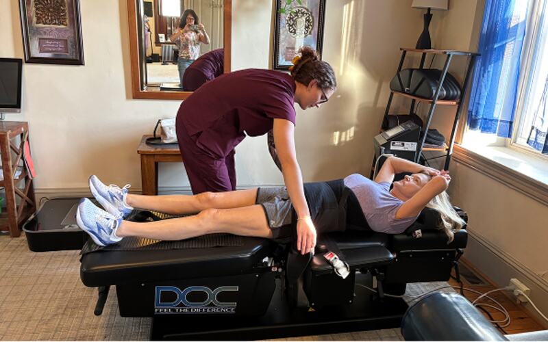 A patient on the spinal decompression table at Kimberton Brain & Body
